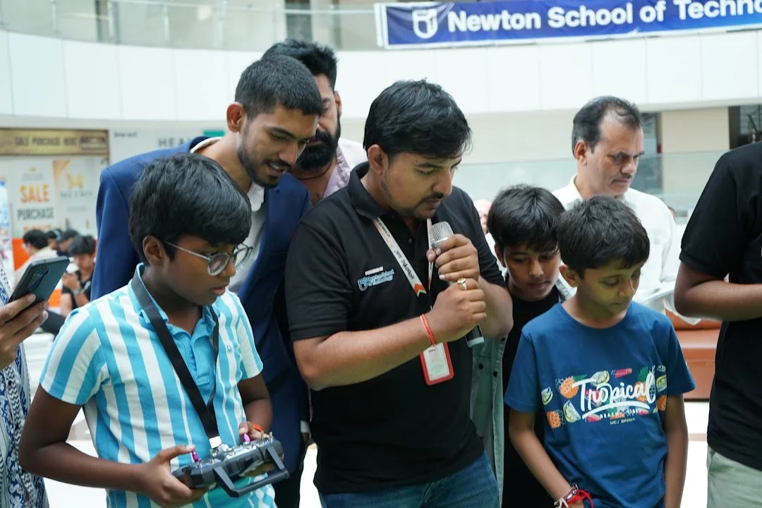 RGI 2026 host engaging young participants beside the competition arena