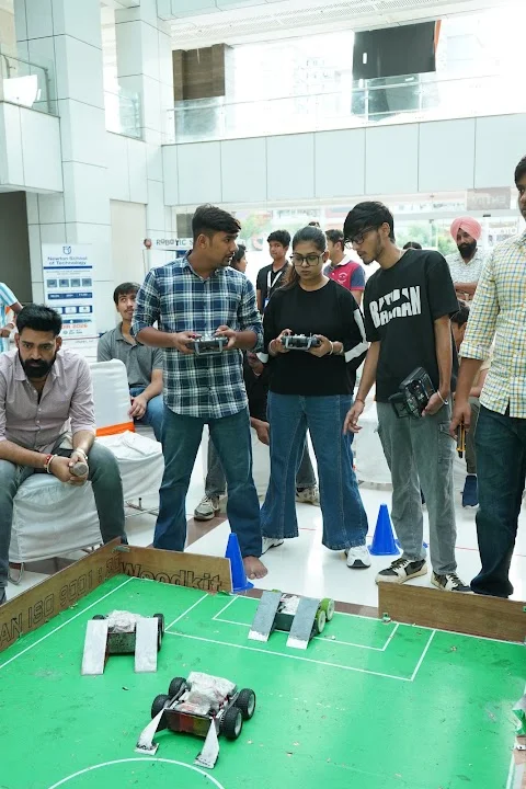 Student team operating soccer robots beside the RGI 2026 arena