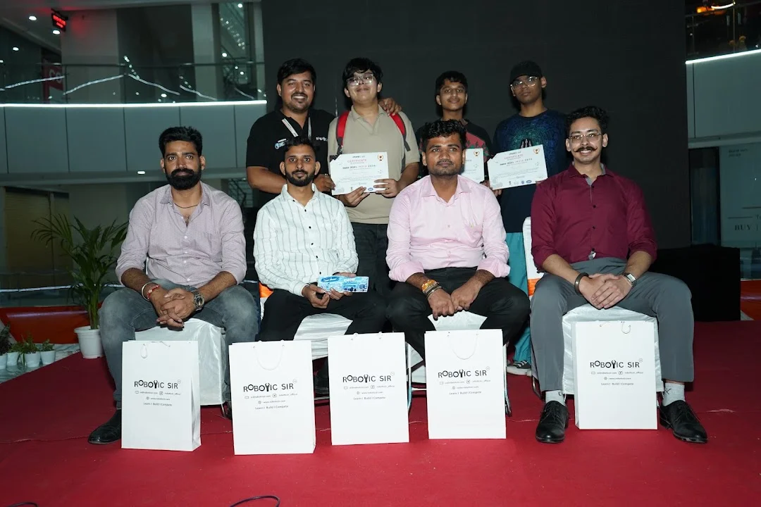 Participants and event officials displaying certificates at RGI 2026